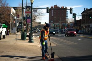 text: a sanitation worker picking up trash