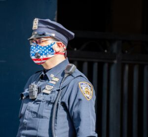 A policeman wearing an American mask
