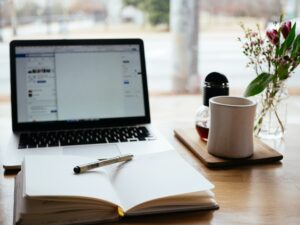 A notebook and a laptop on the table