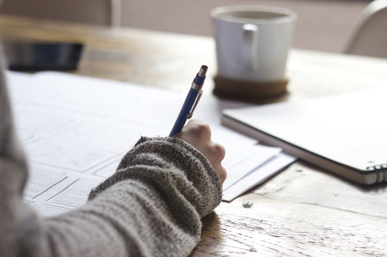 A person writing notes in a notebook