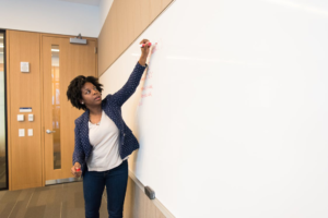 An instructor at a whiteboard teaching a class