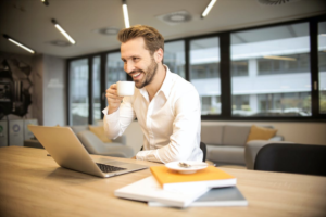 A person drinking coffee and studying