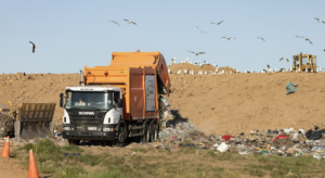 A garbage truck in a landfill