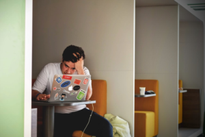 stressed guy looking at the computer screen